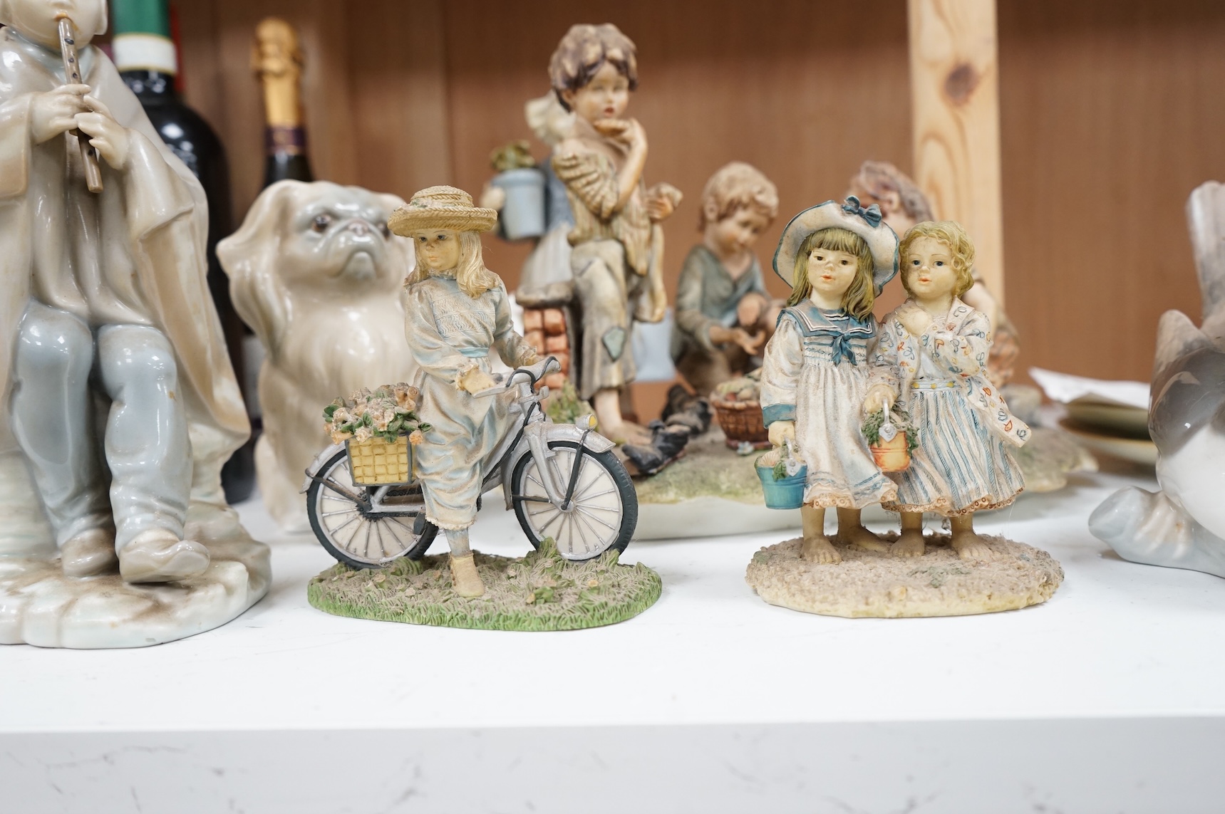 A collection of pottery and porcelain to include a Hayle model of a seal, Lladro figures and a pair of Fairy cabinet plates, largest 27cm wide